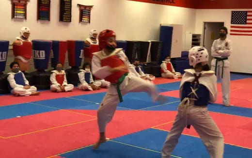 a group of people in a karate class