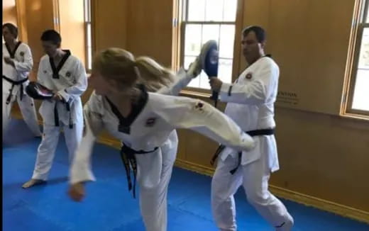 a group of people in karate uniforms