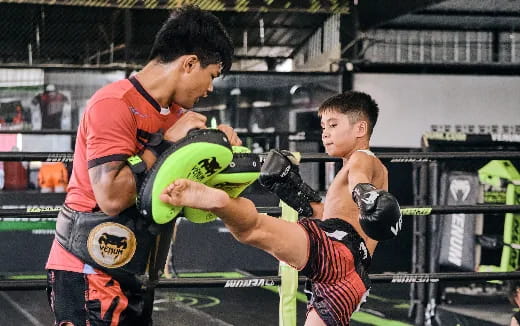 a couple of men fighting in a boxing ring