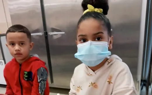 a couple of boys wearing face masks