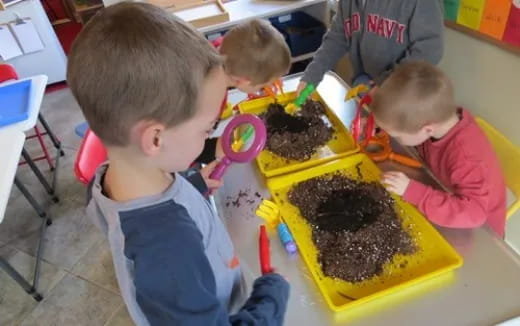 a group of kids playing with a cake