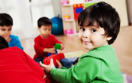 a young boy holding a toy