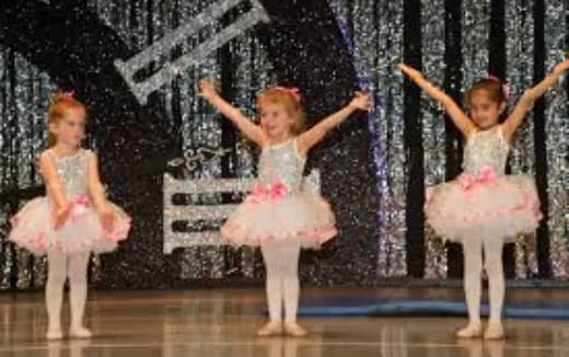a group of children performing on stage