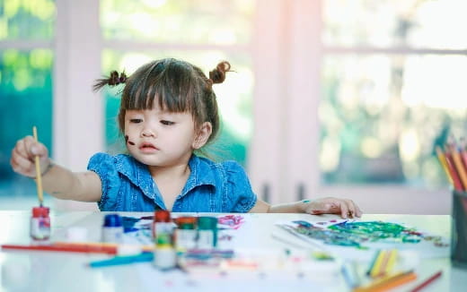 a child painting on a table