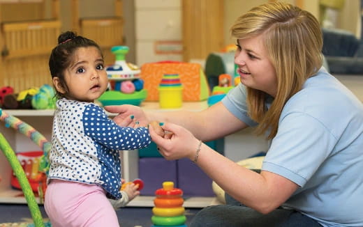 a person and a child playing with toys