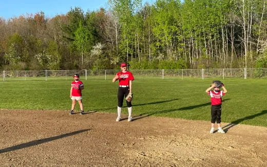 a group of kids playing baseball