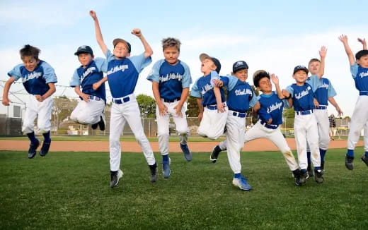a group of people in blue uniforms running on a field