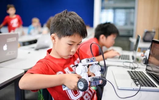 a young boy using a computer