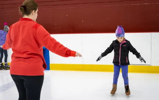 a person and a child ice skating