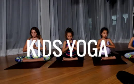 a group of girls sitting on yoga mats