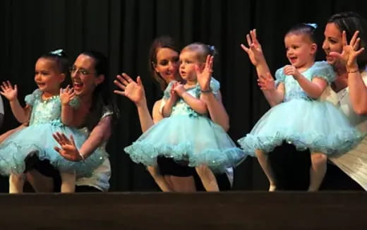 a group of girls in dresses