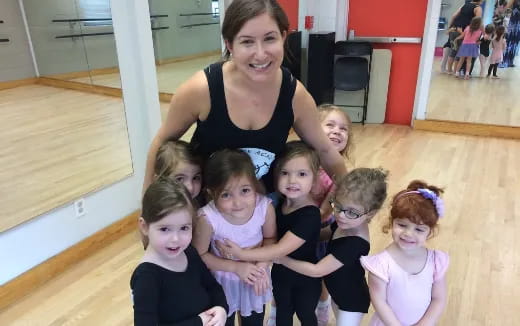 a person standing with a group of children