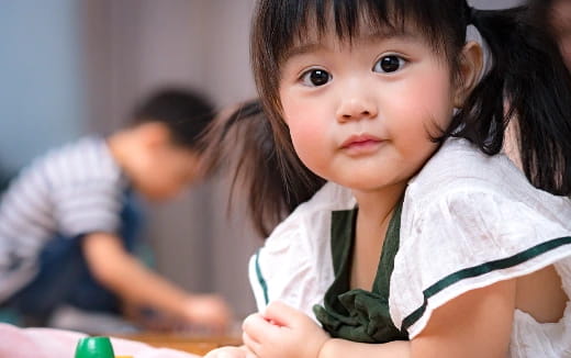 a young girl looking at the camera