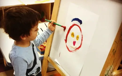 a child drawing on a white board