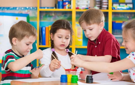 a group of children sitting at a table