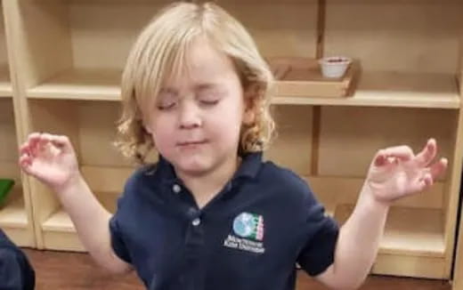 a child with their hands up