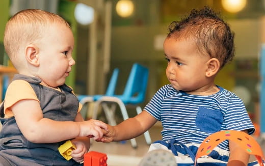 a couple of young boys playing with toys