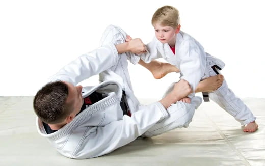 a person and a boy in karate uniforms