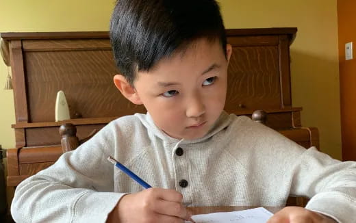 a boy sitting at a table