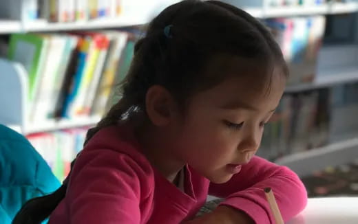 a young girl with a straw in her mouth