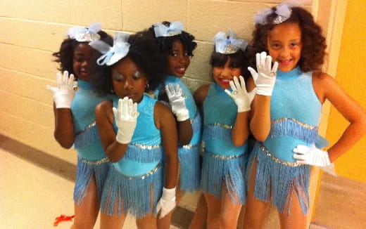 a group of women in blue dresses