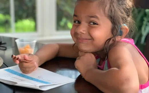 a girl sitting at a table