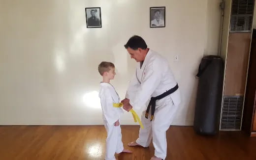 a man and a child in karate uniforms