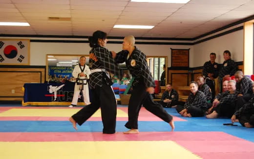 a man and woman dancing in front of a crowd