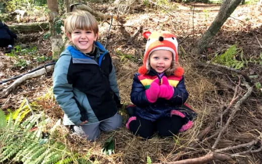 two children sitting in the grass