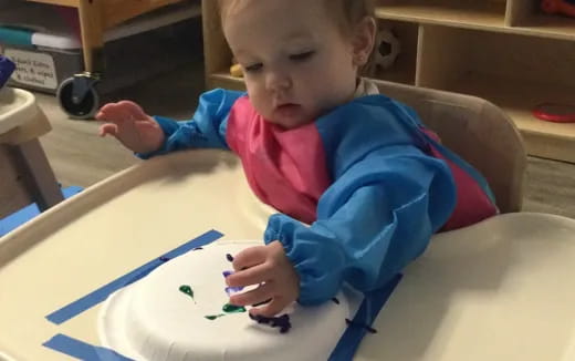 a baby sitting at a table