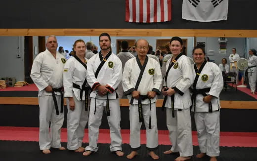 a group of people in white karate uniforms