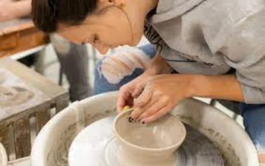 a person pouring liquid into a bowl