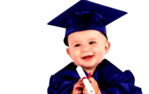 a boy wearing a graduation cap and gown