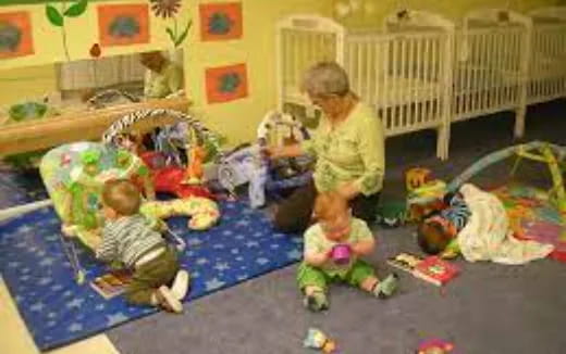 a person and two children sitting on the floor