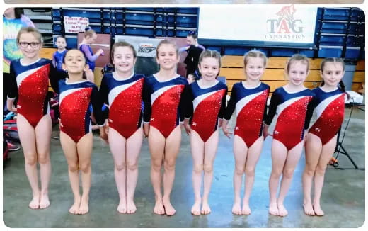 a group of girls in swimsuits posing for a photo
