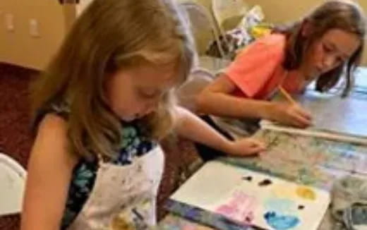 a couple of girls playing with a puzzle