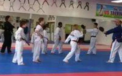 a group of people in karate uniforms