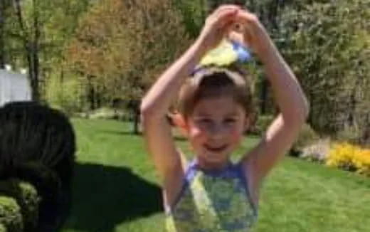 a child with her hands up