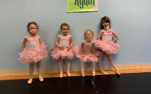 a group of girls in dresses