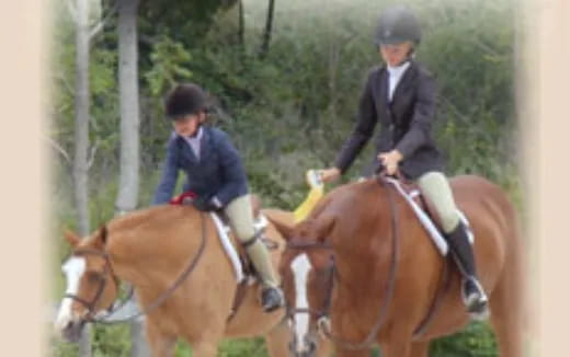 a man and a woman riding horses
