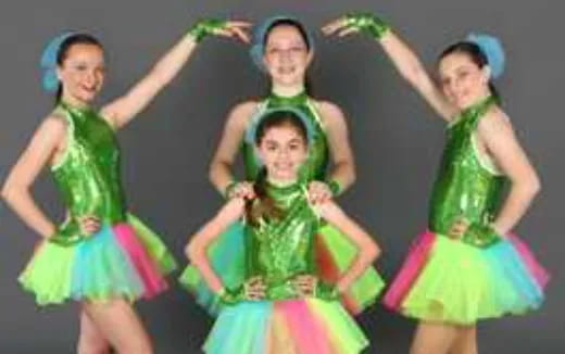 a group of girls in colorful dresses