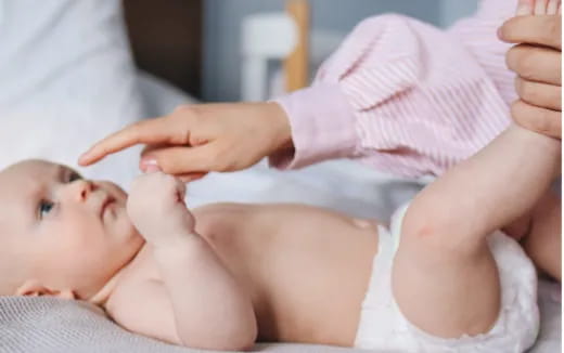 a baby being held by a person