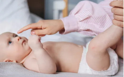 a baby being held by a person