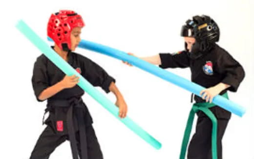 a few men in helmets holding a blue and green object