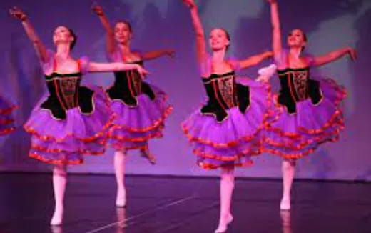 a group of women dancing on a stage