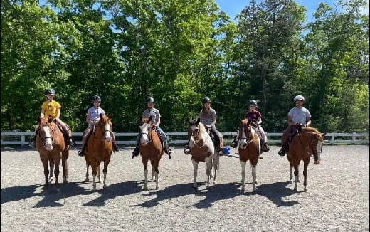 a group of people riding horses