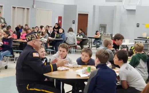a group of children sitting at tables