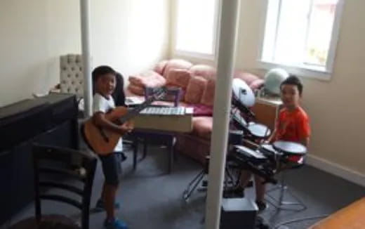 a group of kids playing a piano