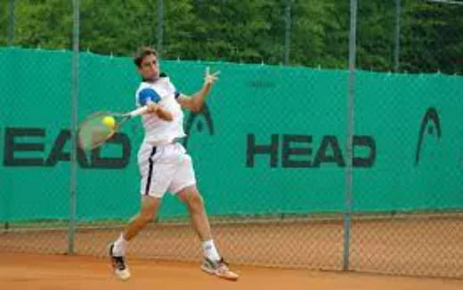 a person hitting a ball with a tennis racket