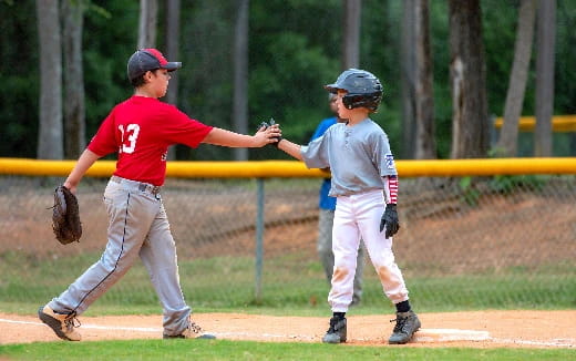 a couple of young boys playing baseball